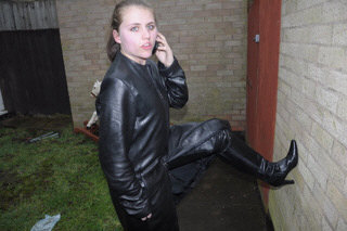 girl-in-leather-jacket-long-leather-boots-on-phone