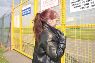 girl-in-leather-pants-leather-gloves-outside-garden