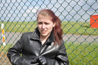 girl-in-leather-pants-leather-gloves-outside-garden