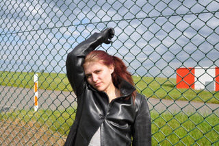 girl-in-leather-pants-leather-gloves-outside-garden