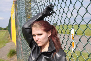 girl-in-leather-pants-leather-gloves-outside-garden