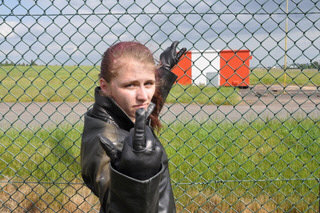 girl-in-leather-pants-leather-gloves-outside-garden