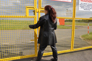 girl-in-leather-pants-leather-gloves-outside-garden