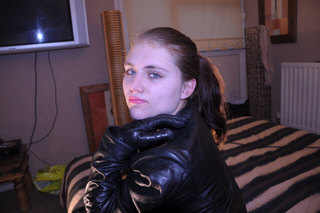 girl-leather-glove-fist-knuckles-tight-grey-room-