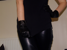 Girl-in-leather-gloves-with-gun-leather-jacket-overknee-leather-boots